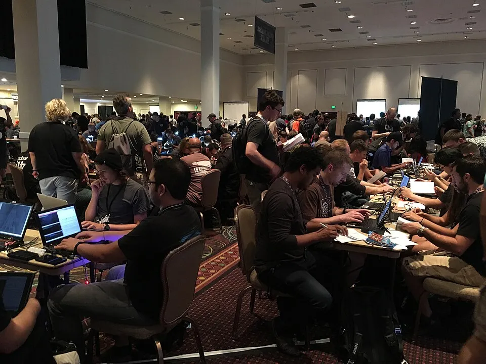 Rows of people at laptops in the contest area of the DEF CON hacking conference