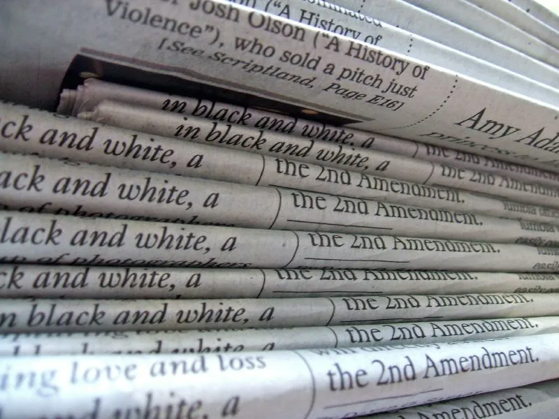 A close-up of a stack of folded newspapers