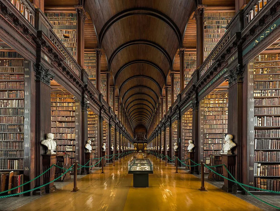 The Long Room library at Trinity College Dublin: a long hall of tall wooden bookshelves under an arched ceiling