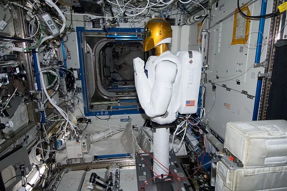 NASA's Robonaut 2, a white humanoid torso with a gold helmet, inside the International Space Station